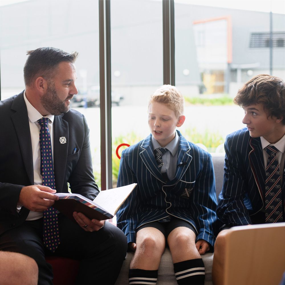 Director of Boarding talking with students.