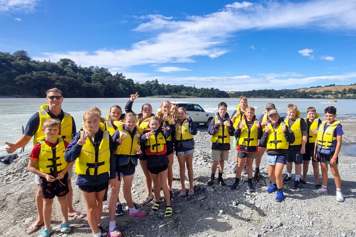 Boarding students at river.