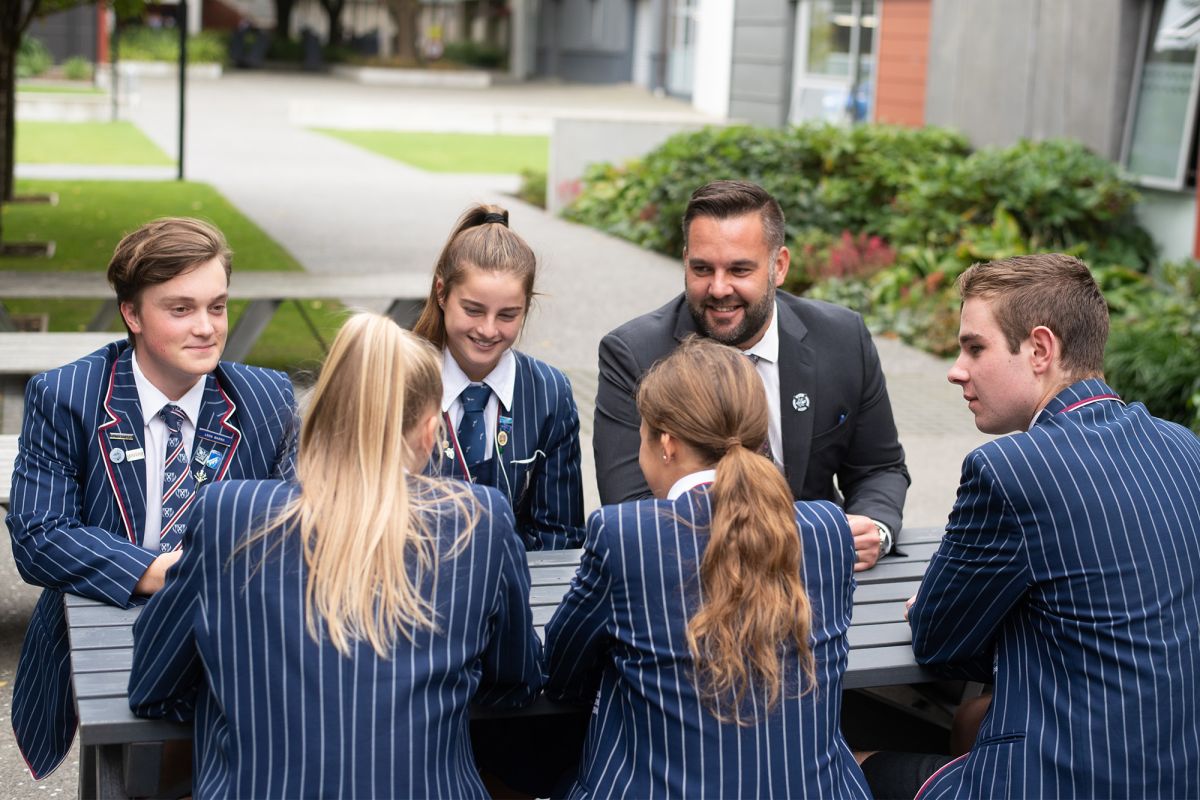 Boarding students with Director of Boarding outside Thompson House.