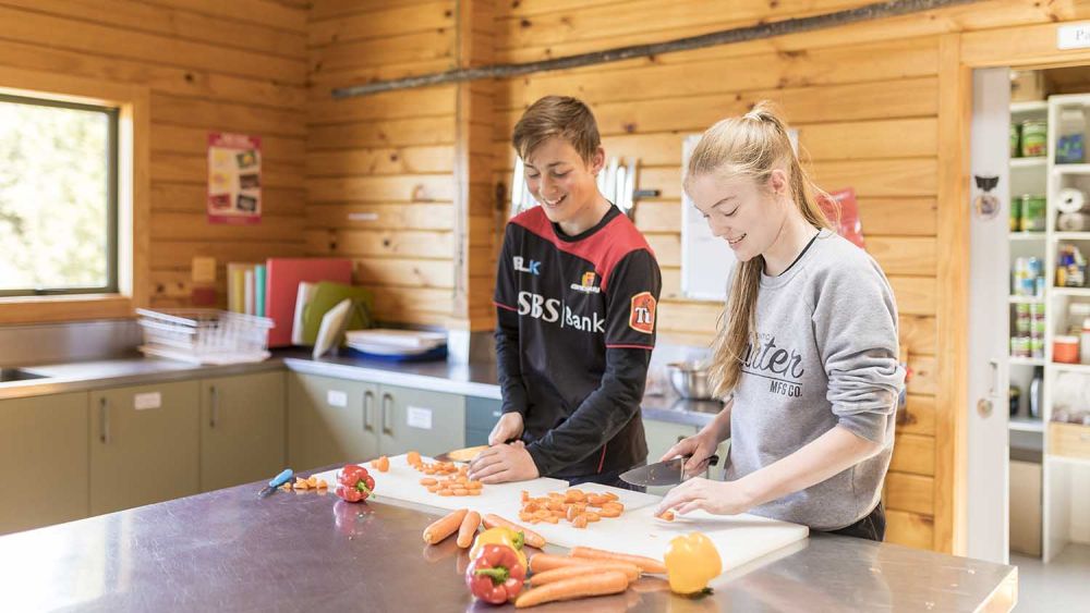 Castle Hill kitchen with students preparing vegetables