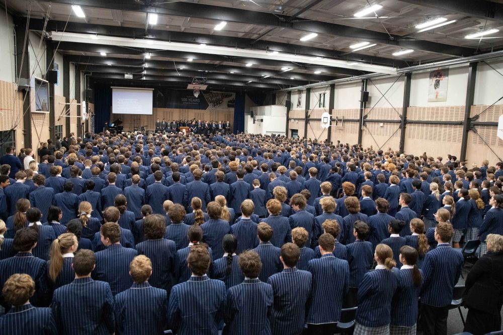 Gym 1 set up with chairs and students for an assembly
