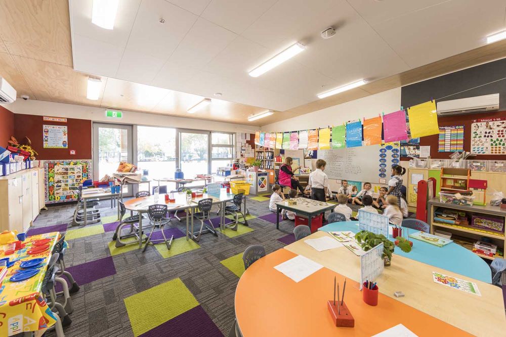 Interior of Junior School classroom with students and teacher at whiteboard at StAC