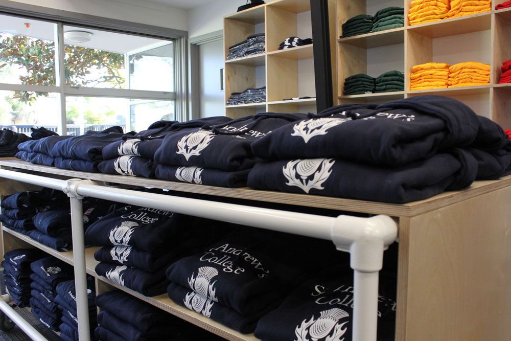 St Andrew's College shop Thistles interior with clothes on racks