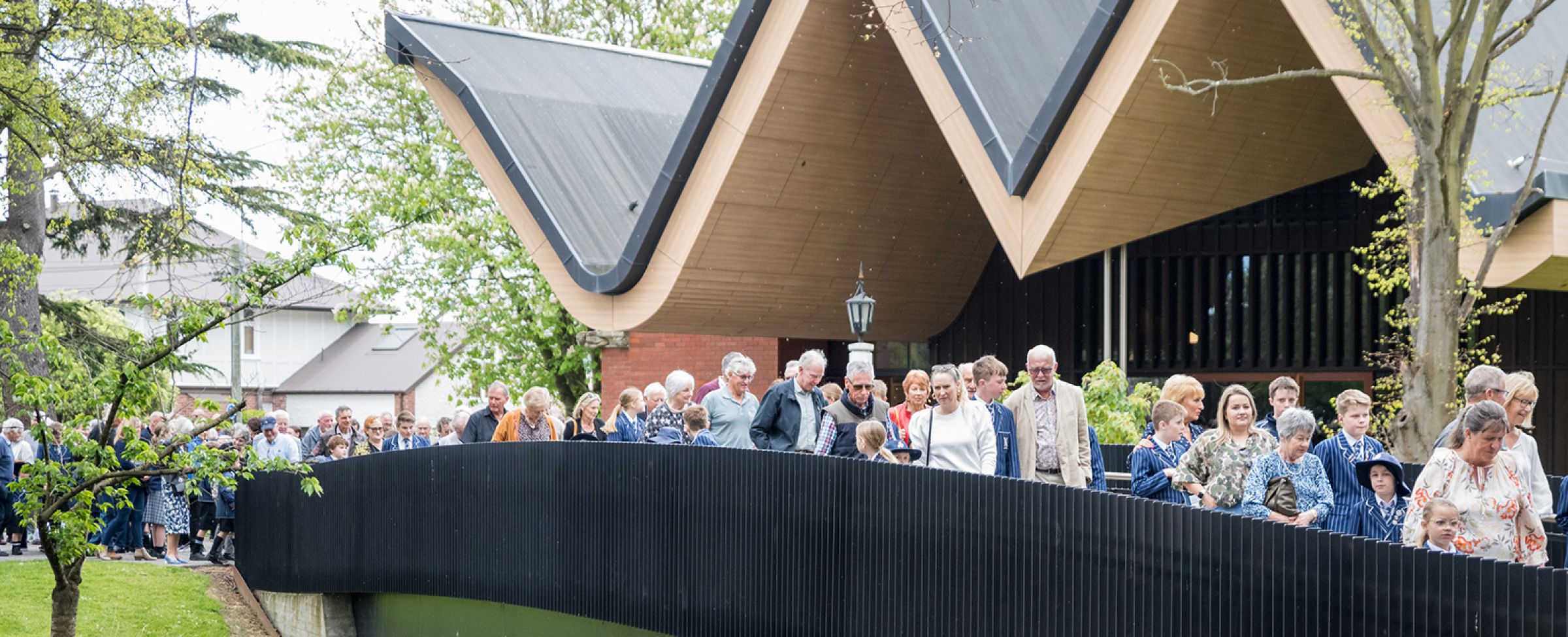 Students and families walking across the bridge.