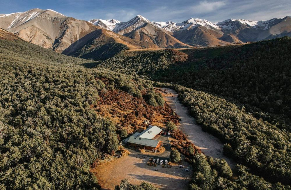 Castle Hill lodge and surrounding mountains drone shot