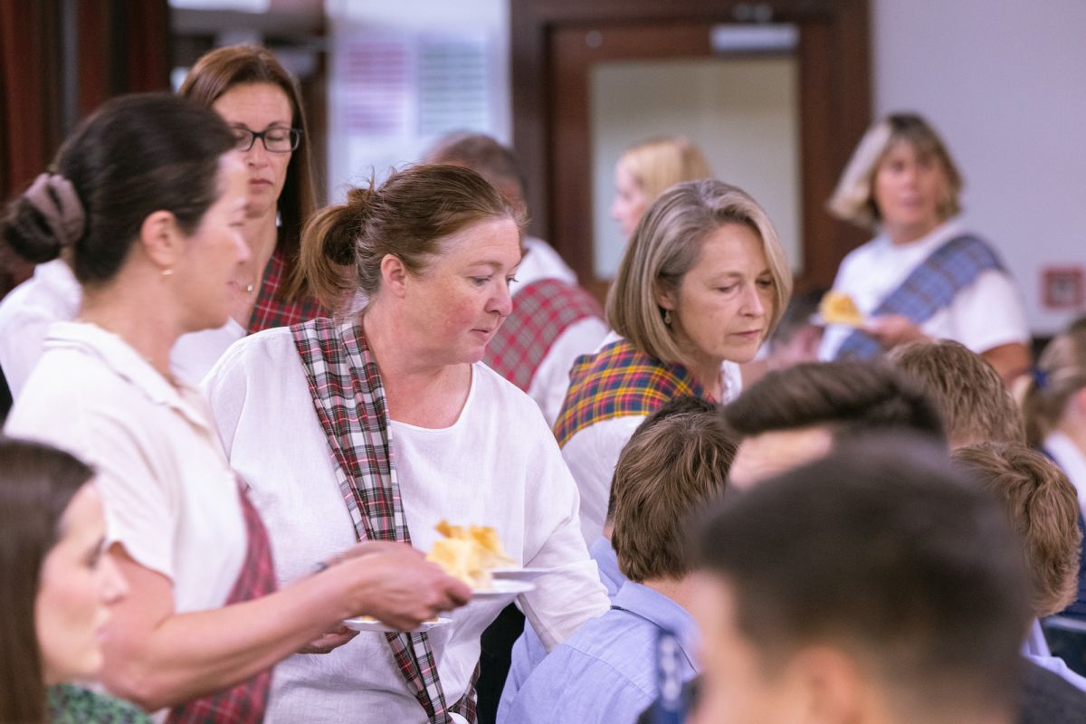 Volunteers serving students at the Boarders Dinner.