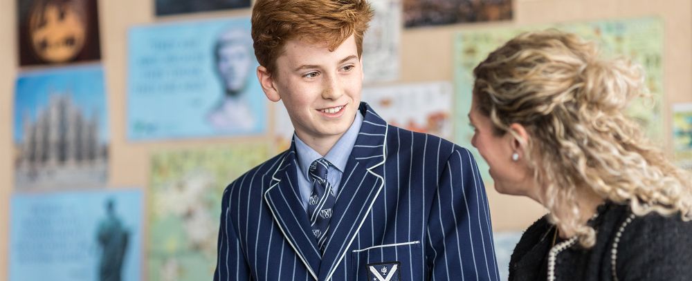 Student and teacher in a classroom.