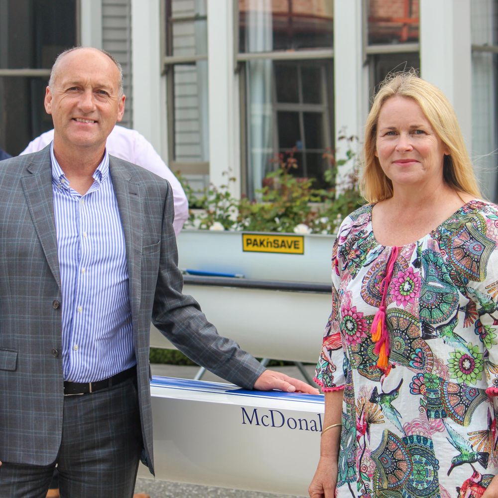 Donors stood in front of boat at naming ceremony at StAC