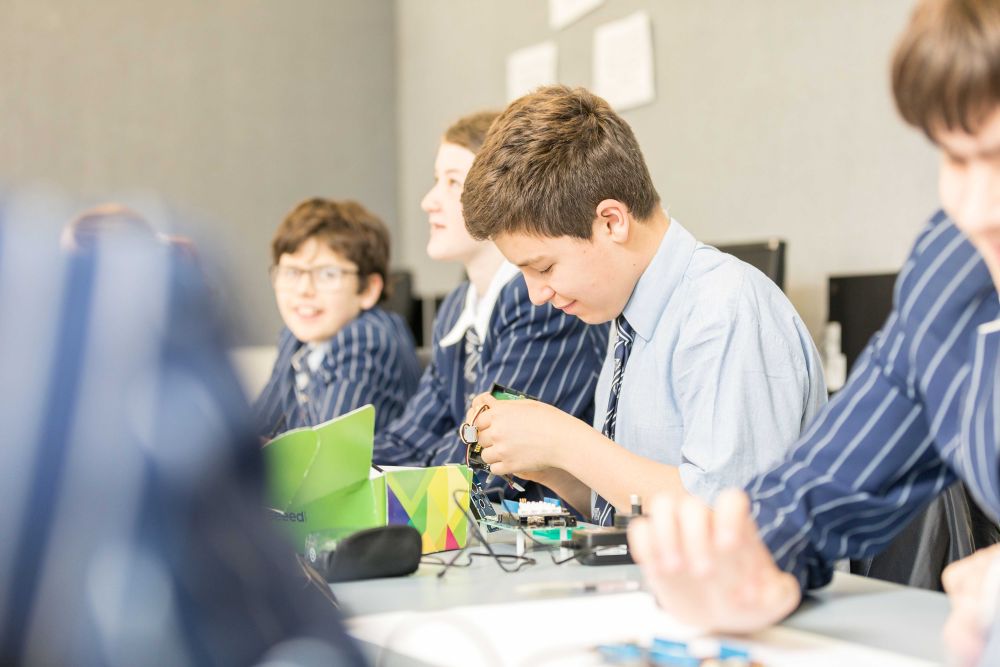 Students in classroom with robotics