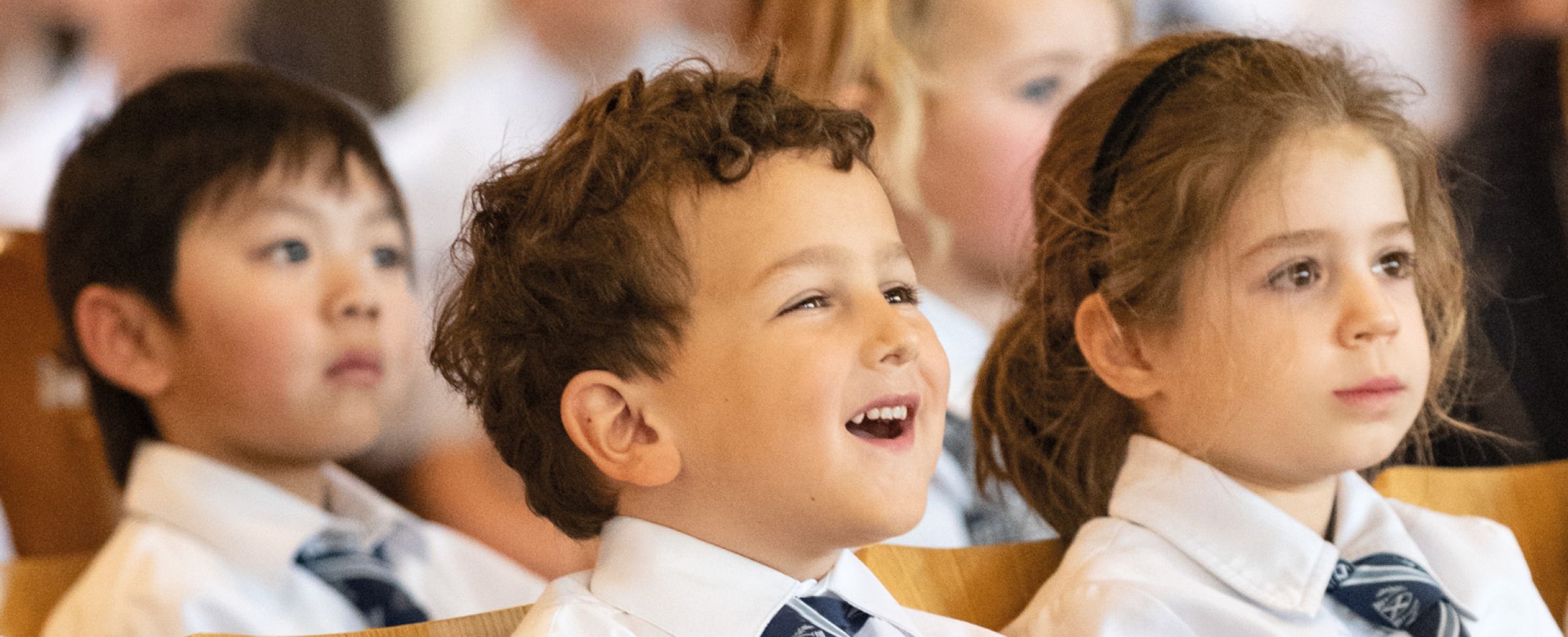 Young students in chapel listening to sermon