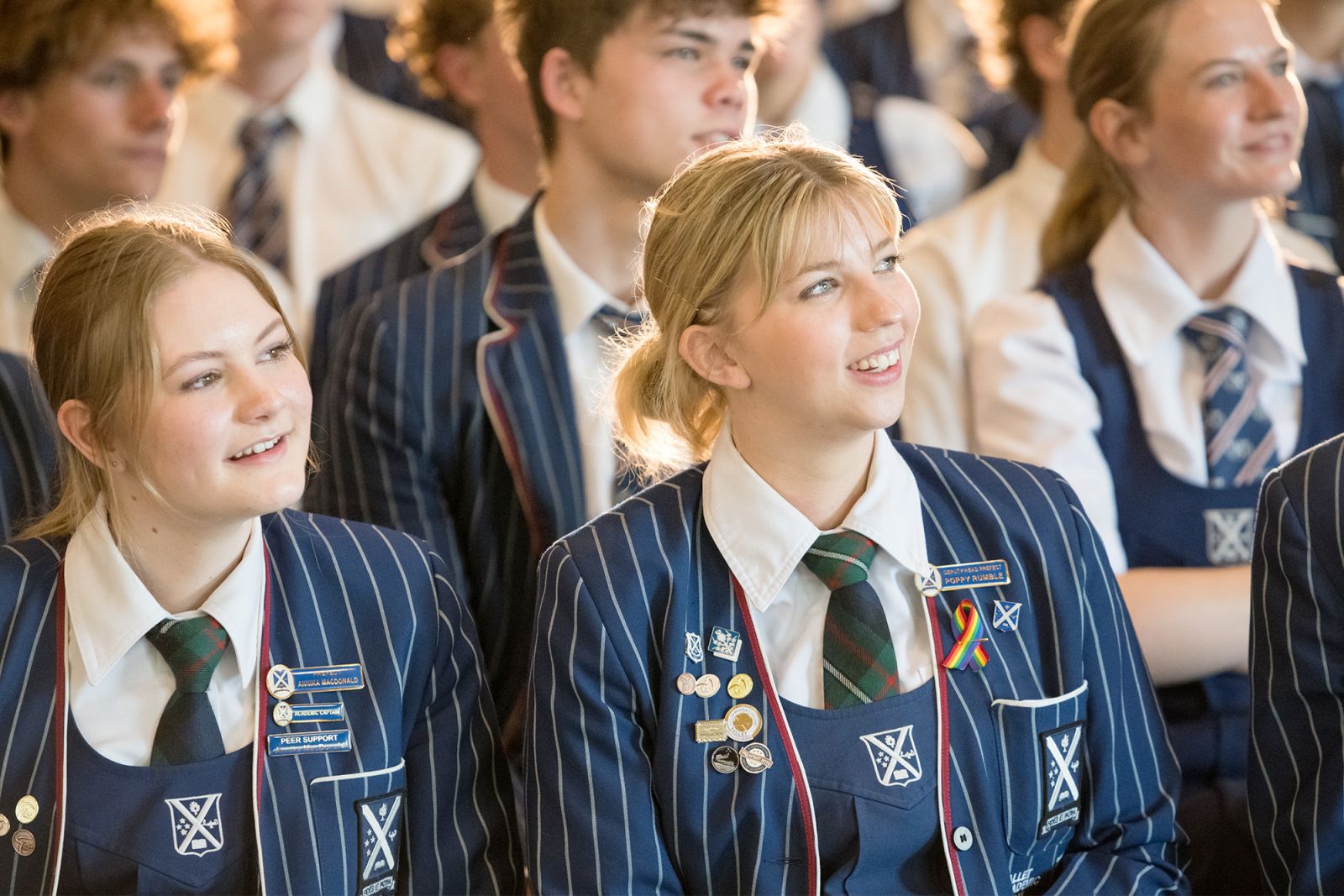 Senior students listening to assembly speaker.