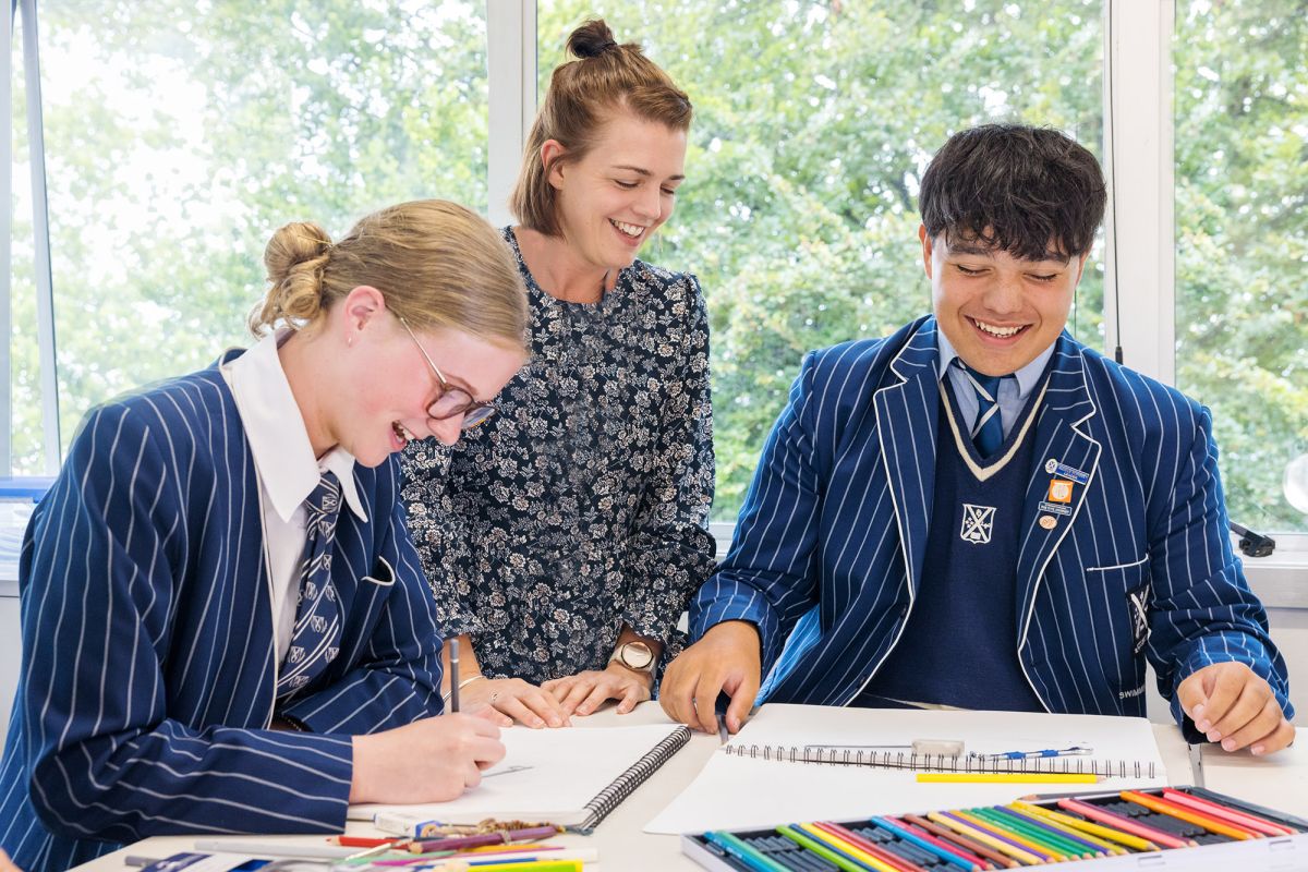 Teacher and students in art class.