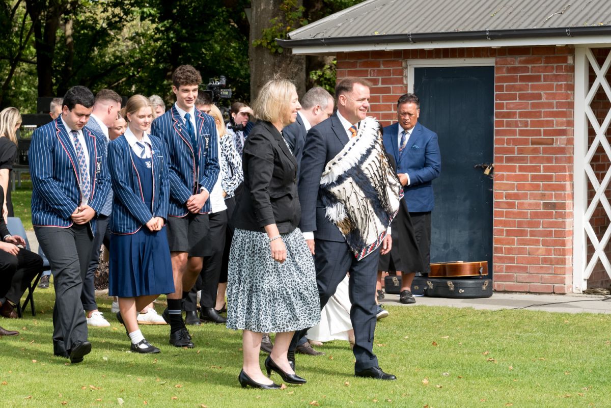 St Andrew's College Rector, Mark Wilson wearing a korowai and walking with Board Chair Felicity Odlin at the 2025 pōwhiri.