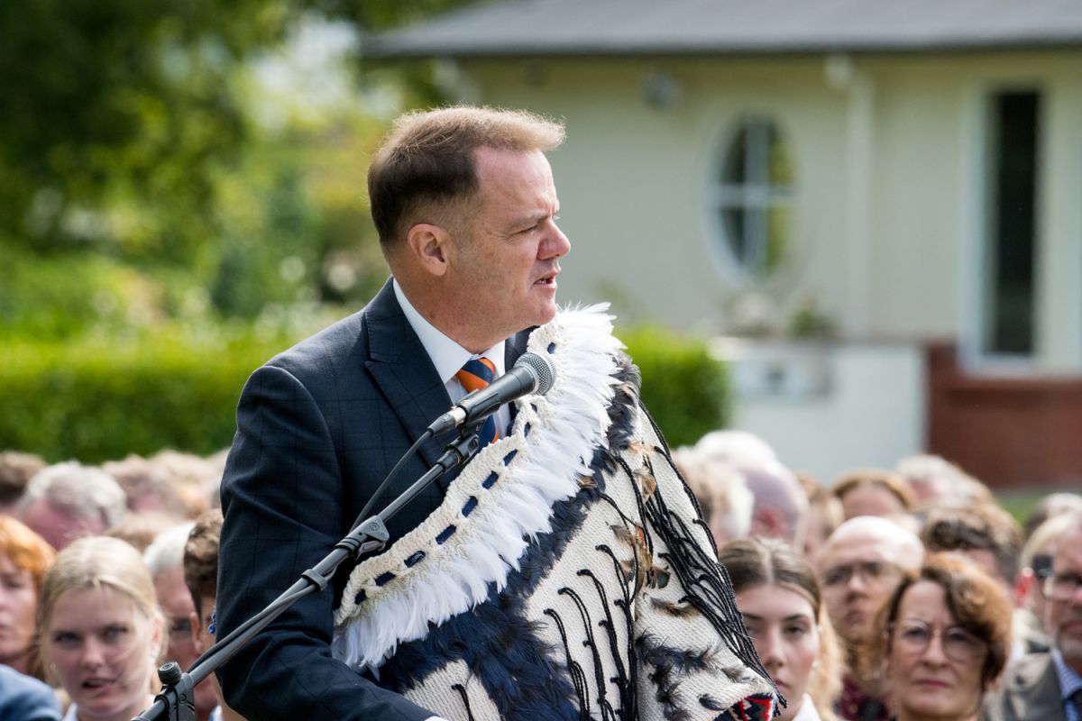 St Andrew's College Rector, Mark Wilson wearing a korowai and speaking at the 2025 pōwhiri.