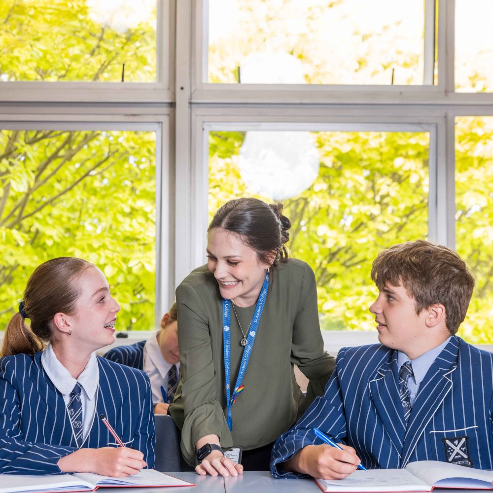 Two St Andrew's College students with a teacher.