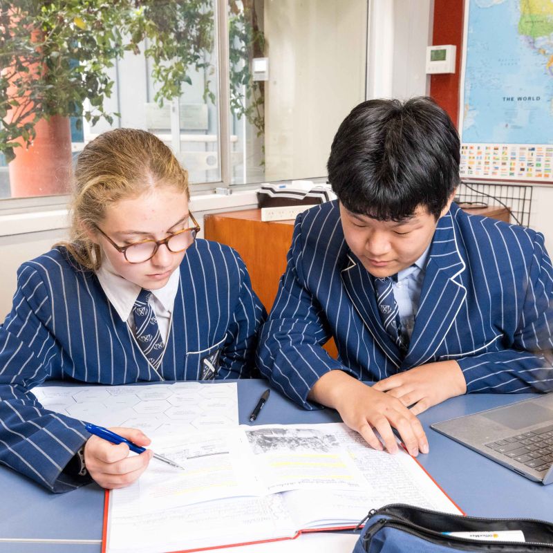 Two St Andrew's College students studying in the classroom.