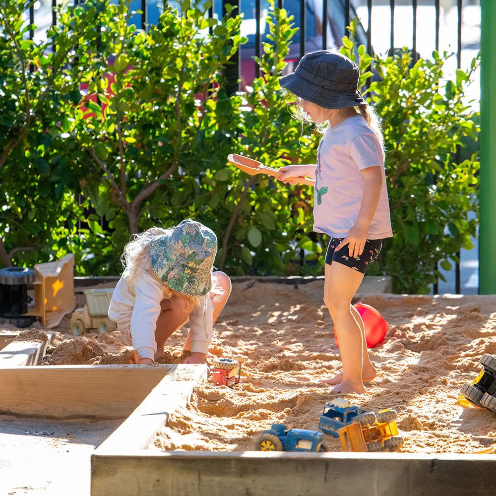 Children playing in the sandpit in the St Andrew's College Pre-school playground.