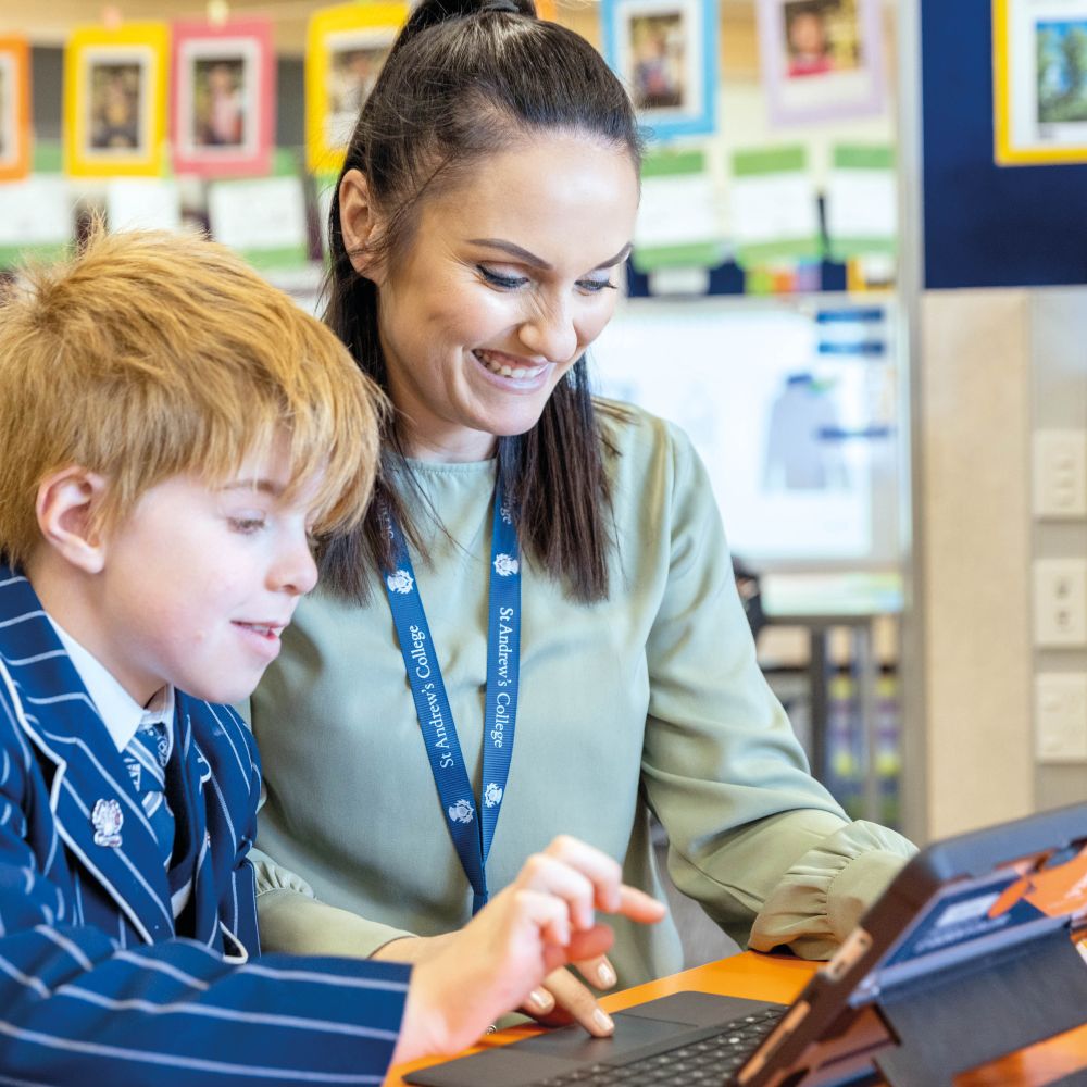 Teacher and Preparatory student working on laptop