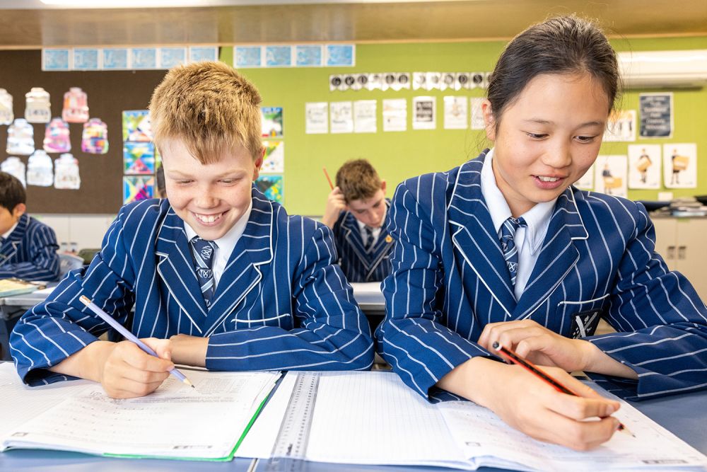 Two St Andrew's College Preparatory School students writing