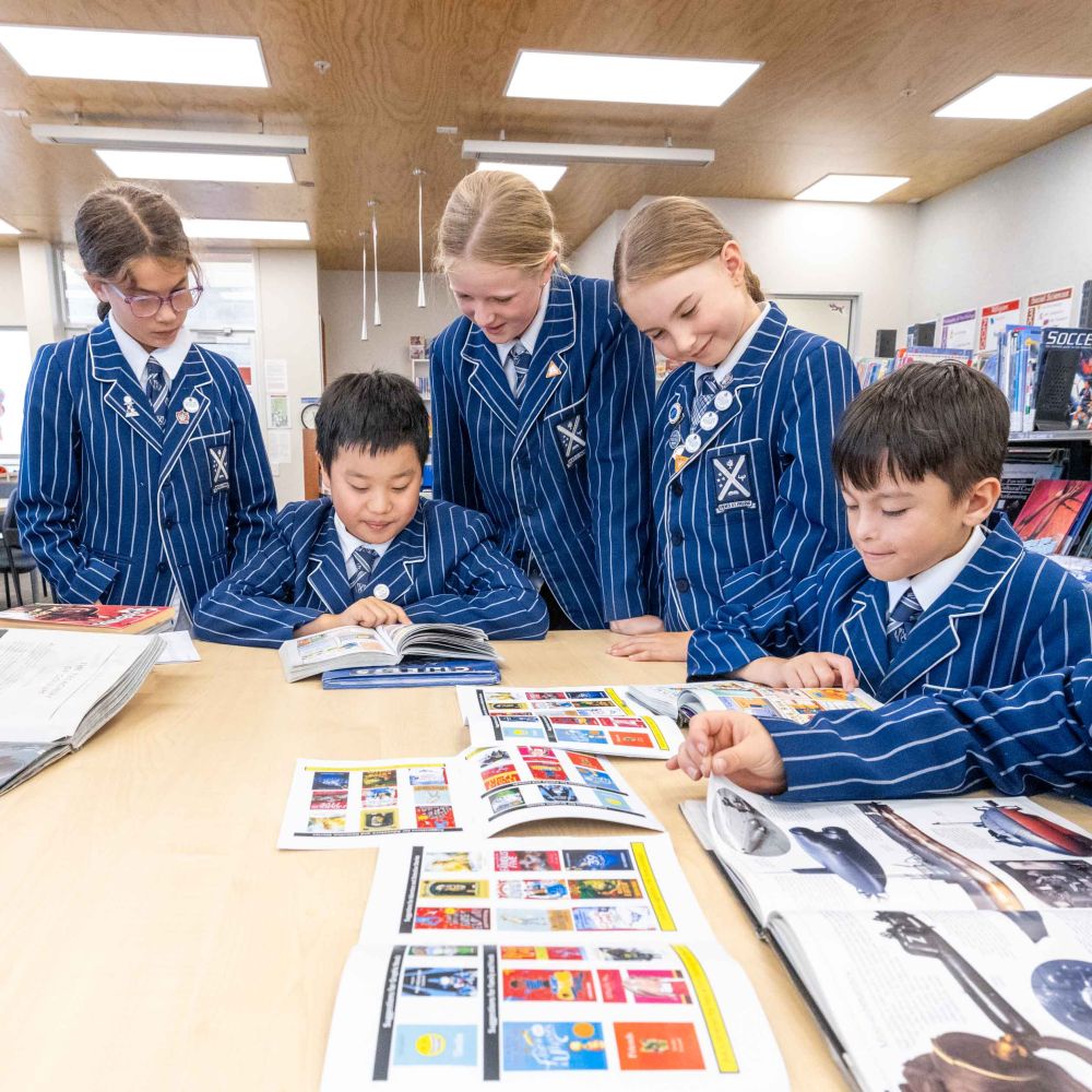 Five St Andrew's College Preparatory School students reading books