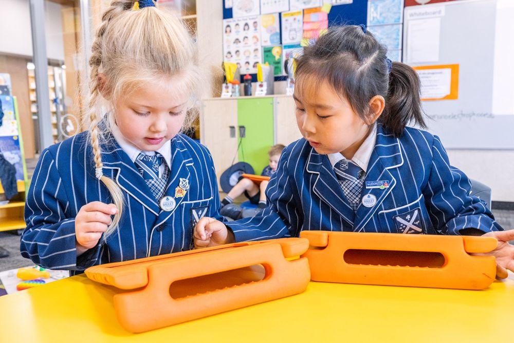 Two St Andrew's College Preparatory School students working on their tablets