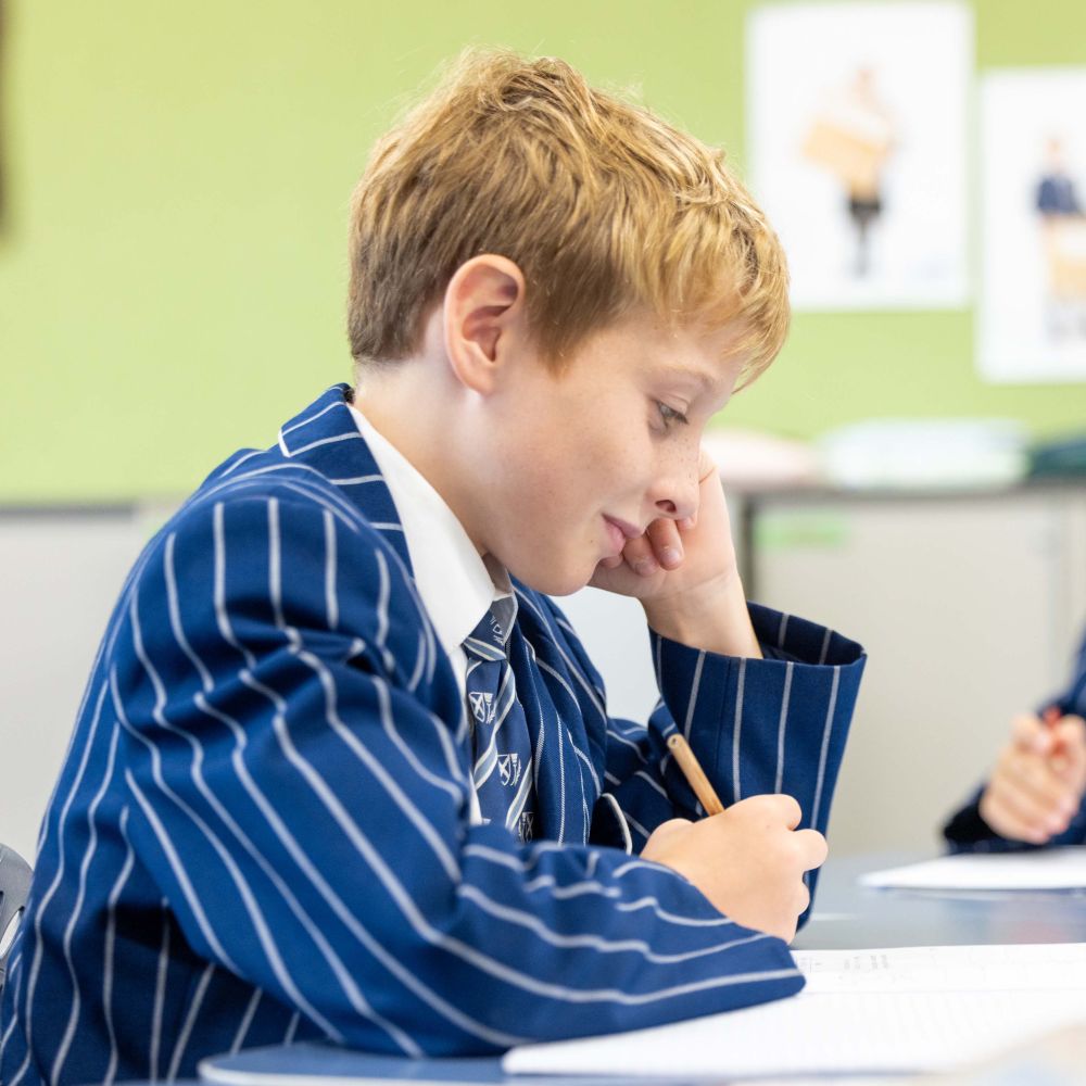 St Andrew's College Preparatory School student writing