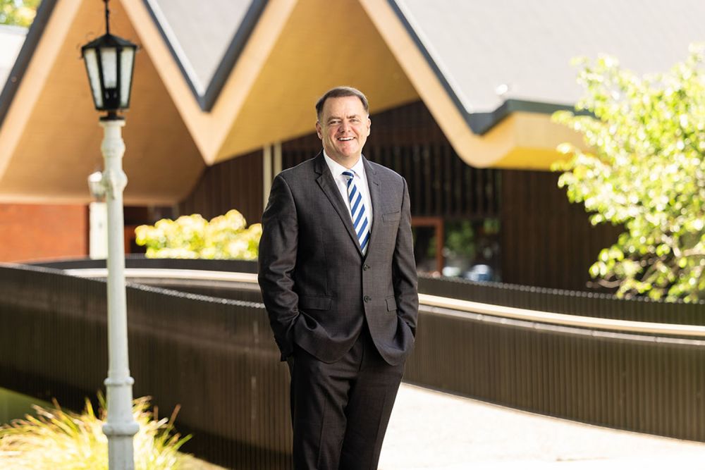 St Andrew's College Rector, Mark Wilson in front of the Centennial Chapel.