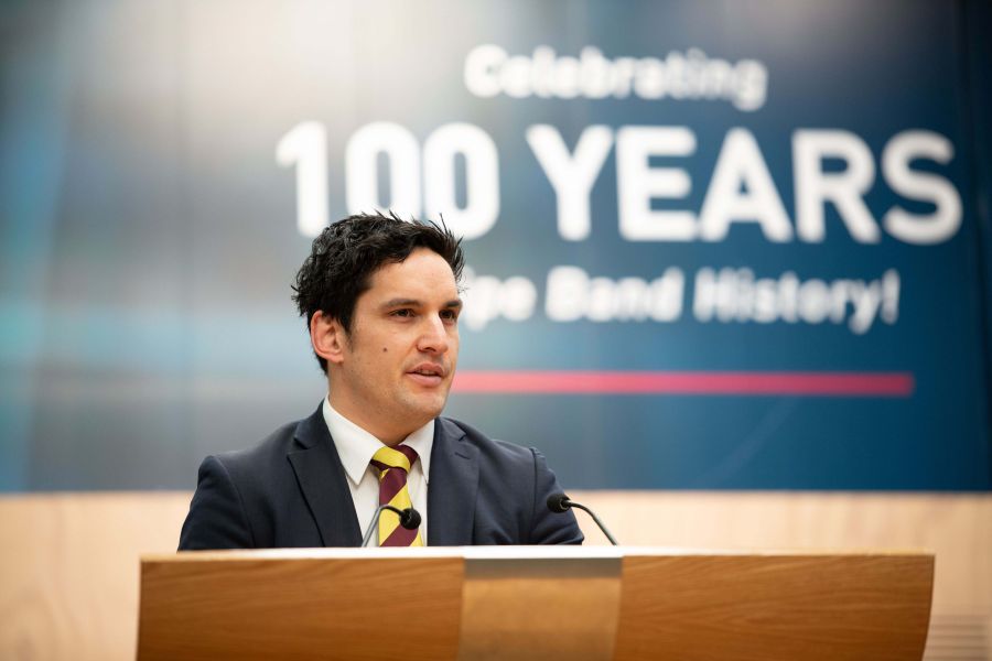 Teacher presenting to students at assembly