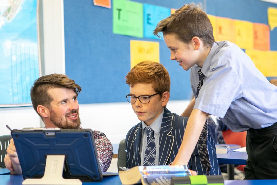 Students working in the classroom with their teacher