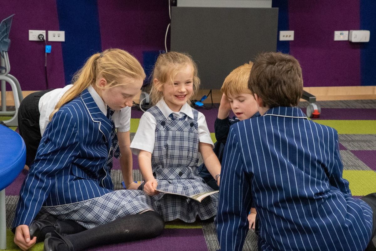 Preparatory students sharing a book together