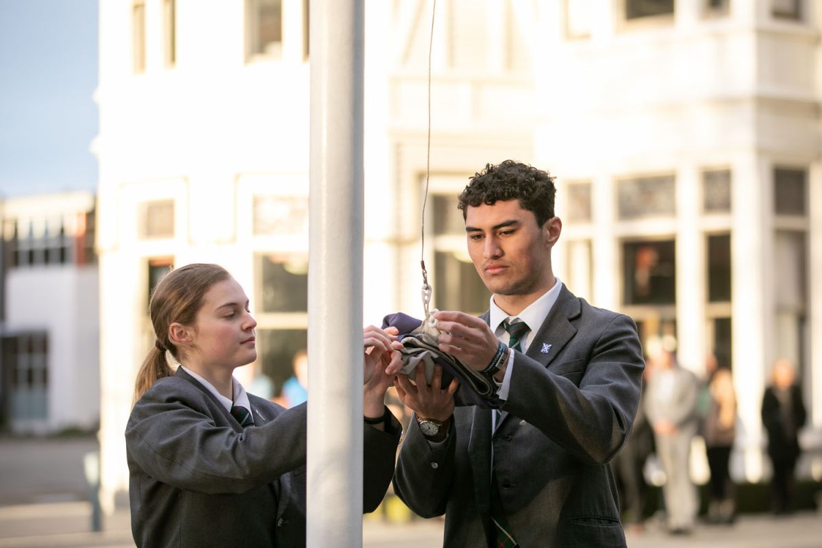 Prefects raising the school flag