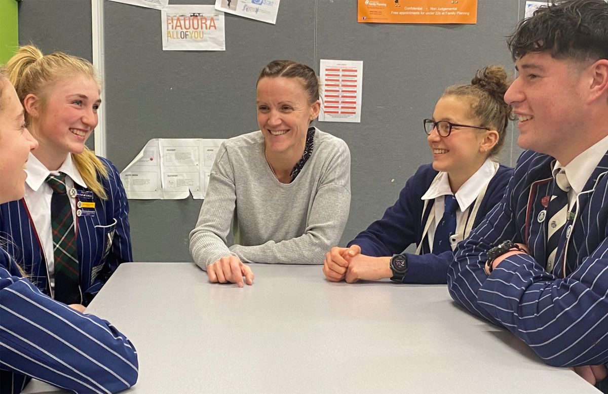 teacher in discussion with students