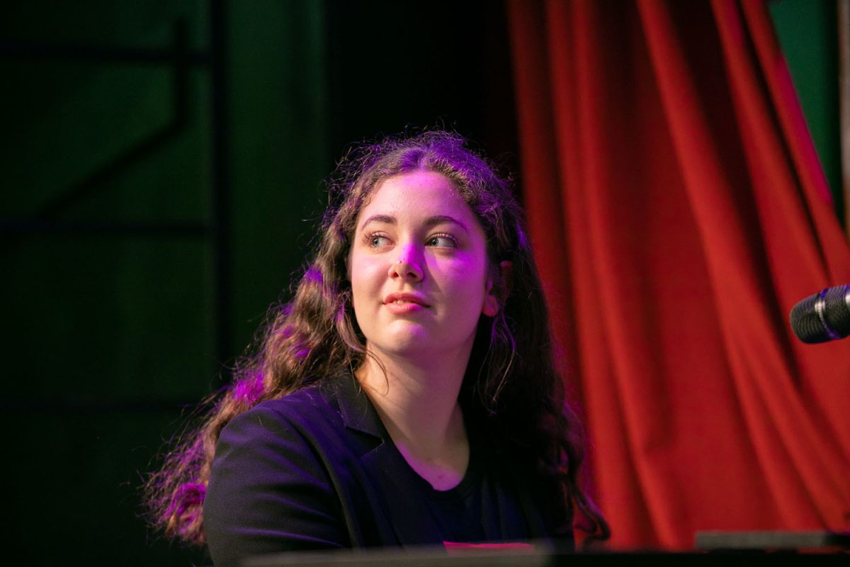 student looking out to the crowd whilst performing on stage