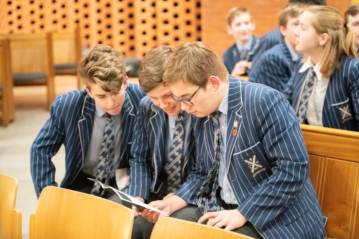 Students huddled in assembly