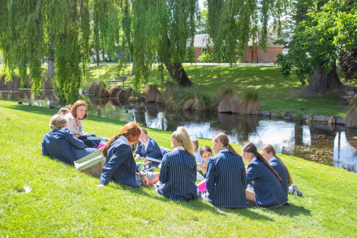 students spending time with a teacher in a casual setting