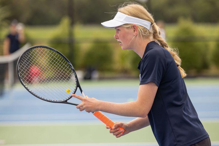 St Andrew's College student preparing to return a serve at a tennis match