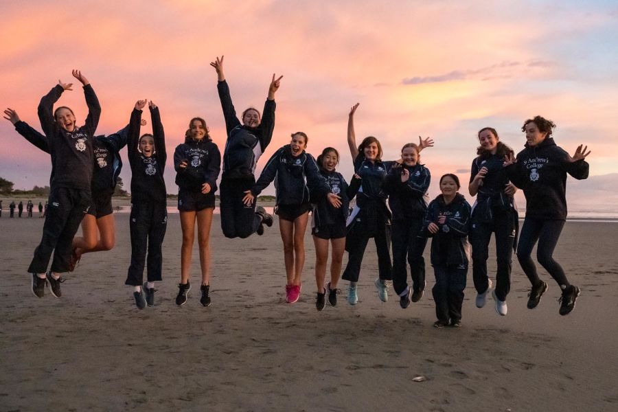Students on the beach jumping