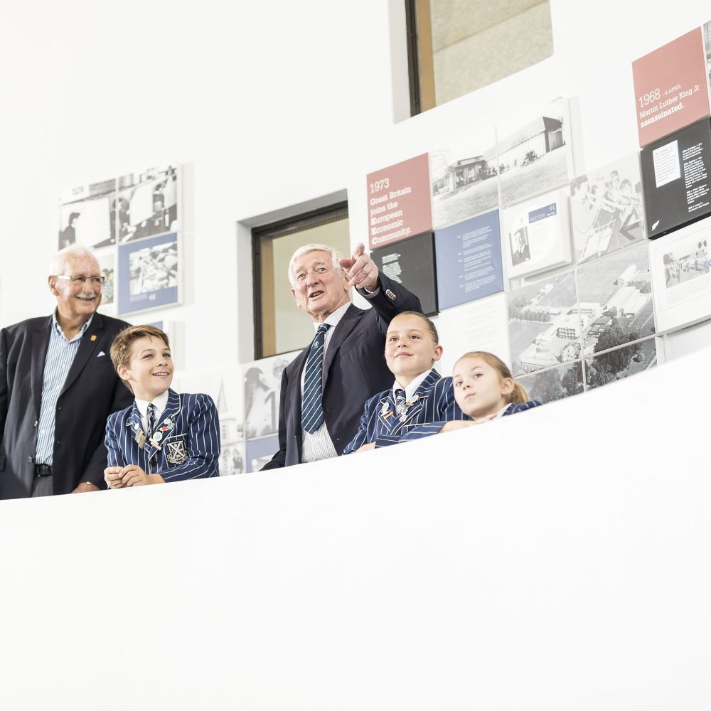 Old Collegians and students viewing the StAC100 timeline
