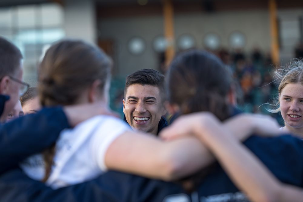 Football Co-ordinator celebrating with students.