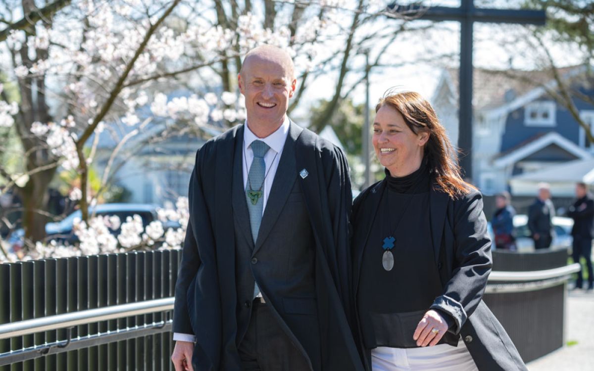 Rev Paul Morrow walking over bridge at St Andrew's College
