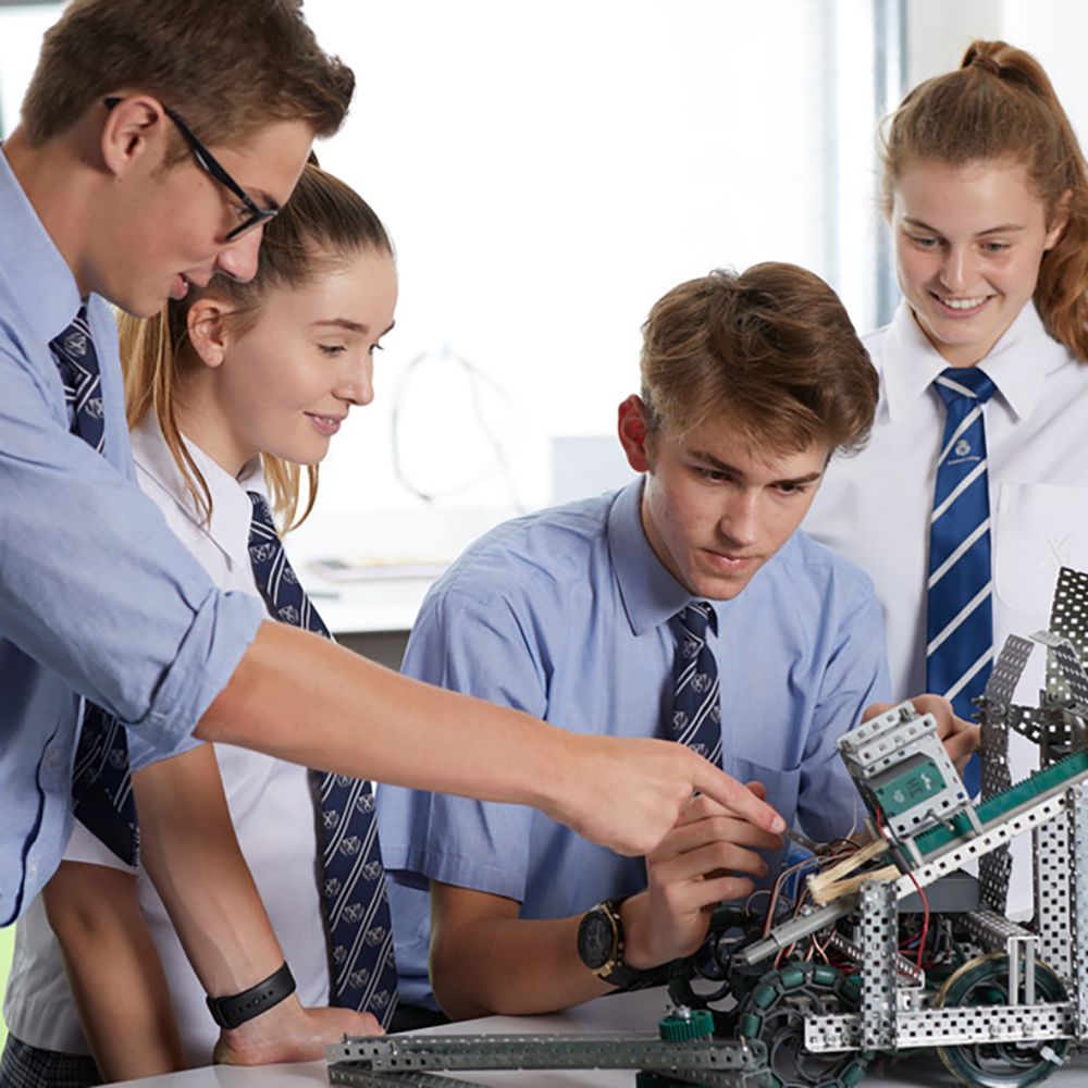 Students working on VEX robot in a group